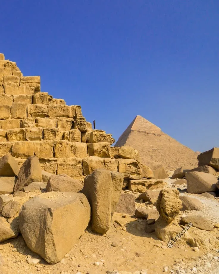 The Great Sphinx with a pyramid rising behind it at Giza