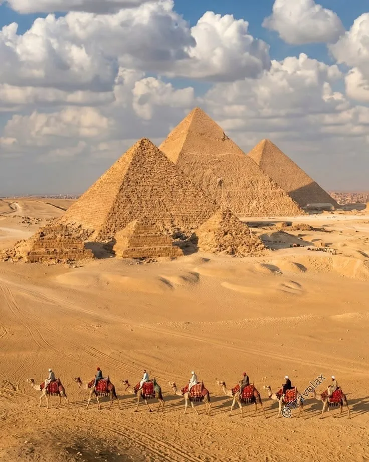The pyramids of Giza rising from the desert with the Sphinx before them
