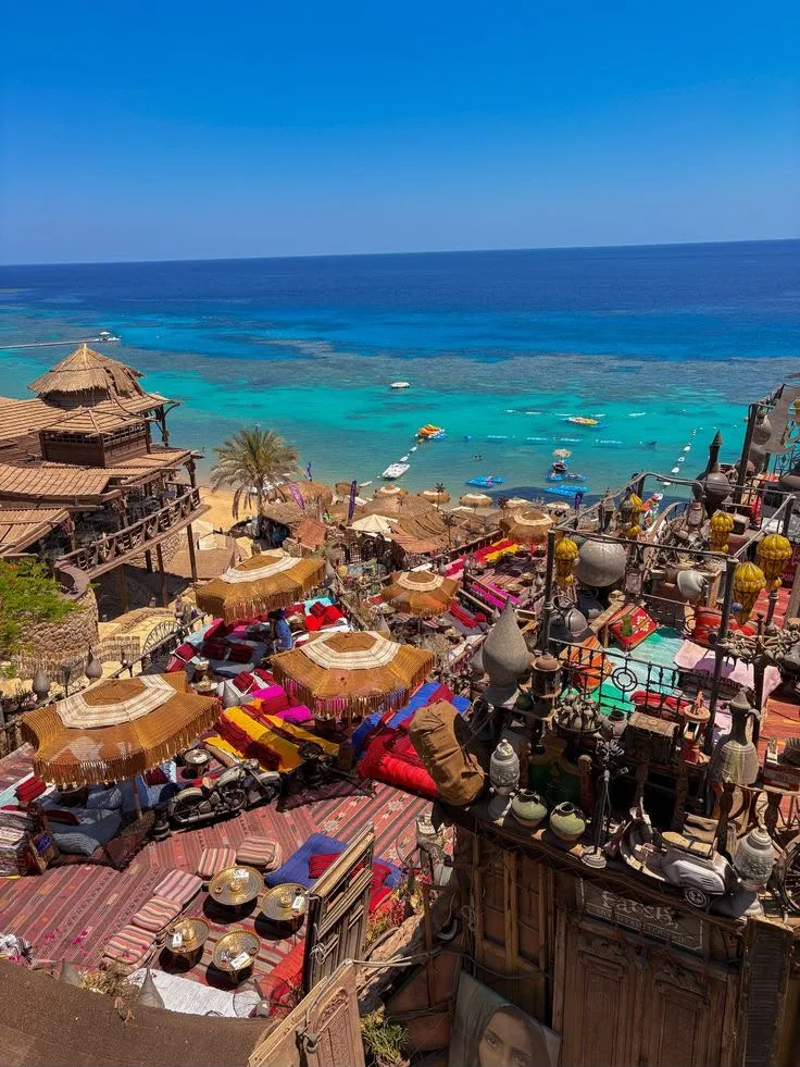 A thatched beach camp above the coral reef shallows of the Red Sea at Sharm El Sheikh